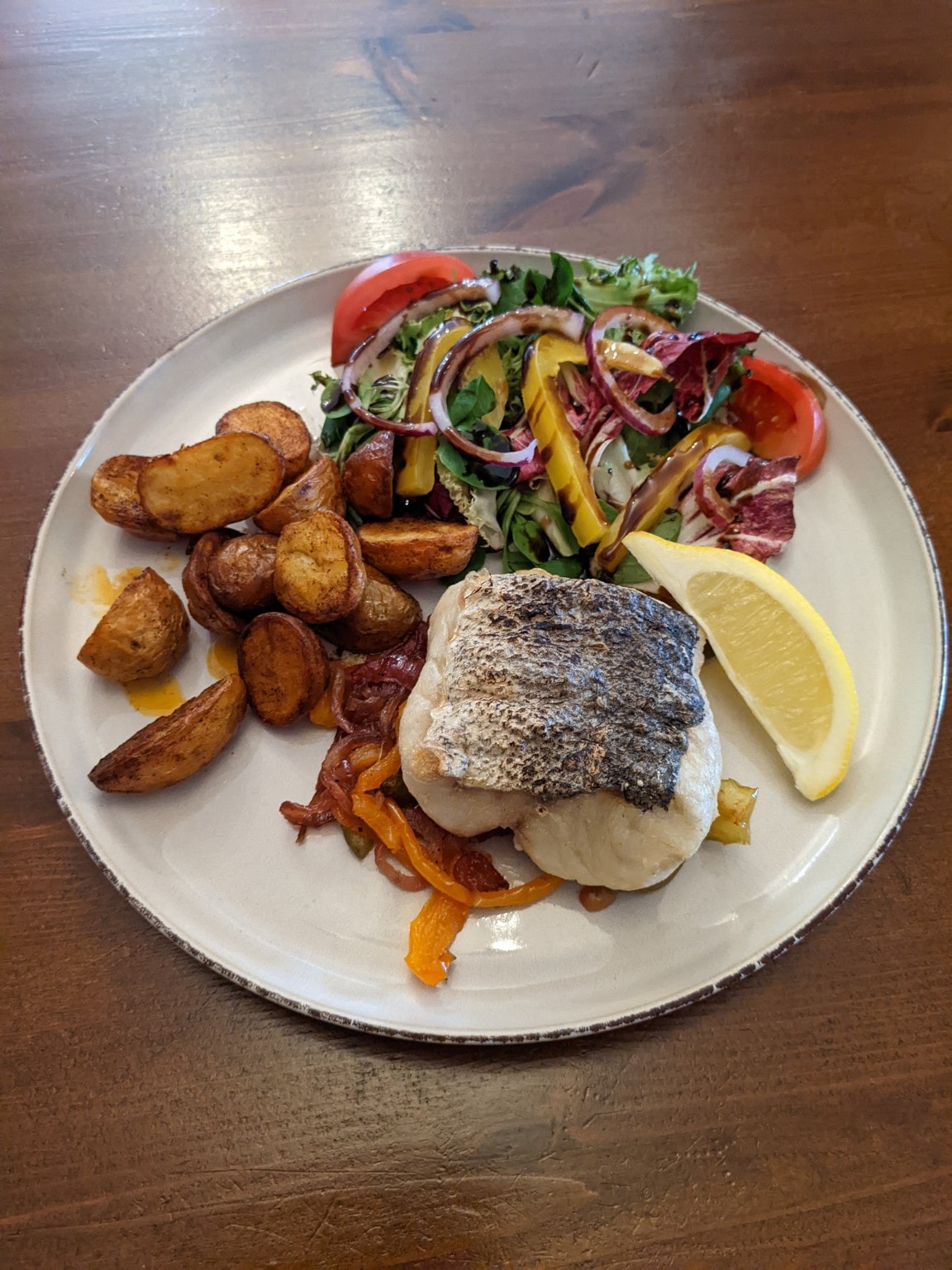 Pan-fried fish fillet with roasted potatoes and mixed salad